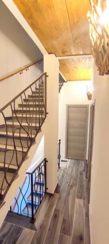 a hallway with a spiral staircase in a house at Sa Terra Mea - Luxury Apartment in Torpè