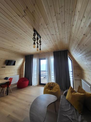 a living room with a couch and a table at Kai cottage in Gudauri