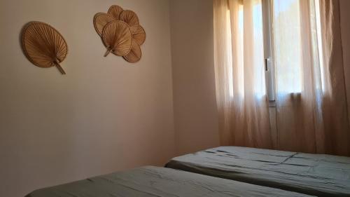 sypialnia z 2 łóżkami pojedynczymi i oknem w obiekcie Maison individuelle entierement rénovée w mieście Porto-Vecchio
