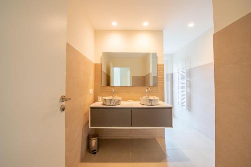 a bathroom with a sink and a mirror at Villa le Roi Soleil in Saint-Tropez