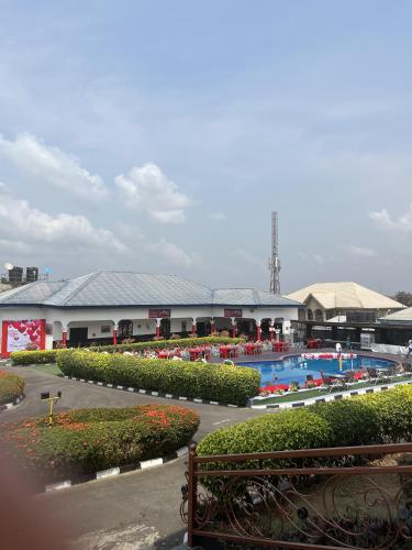 a resort with a swimming pool and a building at Teny Homes in Calabar