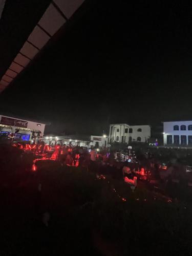 Eine Menschenmenge, die nachts im Dunkeln sitzt in der Unterkunft Teny Homes in Calabar