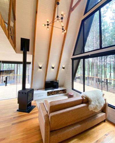 a living room with a couch and a fireplace at Cabana Alameda Black in Cambara do Sul