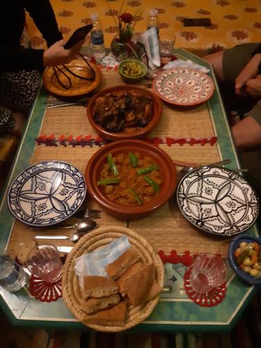 a table with plates of food on it at Dar Pa Labzioui in Meknès