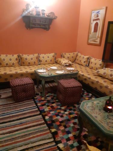 a living room with a couch and a table at Dar Pa Labzioui in Meknès