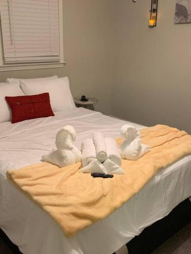 a bed with three towel animals on top of it at Good Vibe in the heart of Plaza/Midwood area in Charlotte