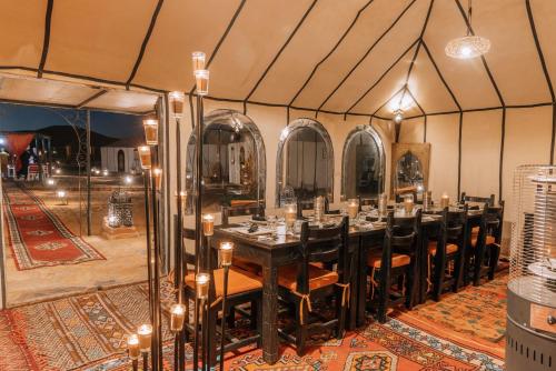 a dining room with a table in a tent at Tiziri Camp in Merzouga