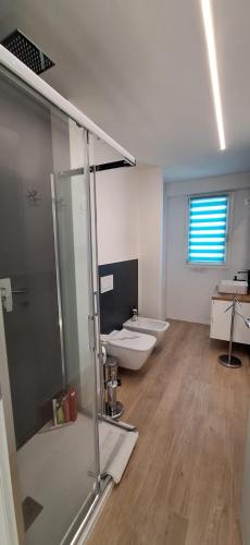 a bathroom with a toilet and a glass shower at Beach house in Cavo