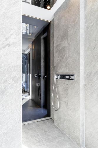 a bathroom with a shower with a glass door at Hollywood Dream Penthouse & Apartments mit privater Sauna nahe Ischgl in Kappl