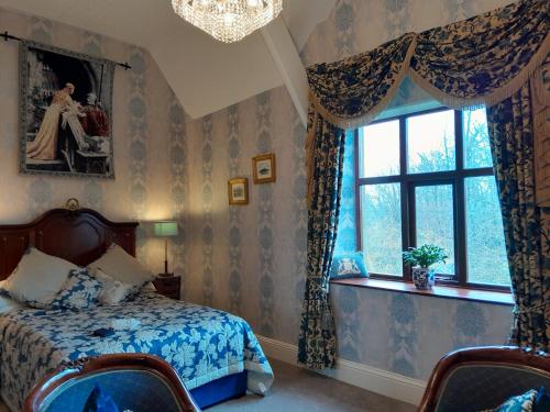 a bedroom with a bed and a window at St David's Guesthouse in Haverfordwest