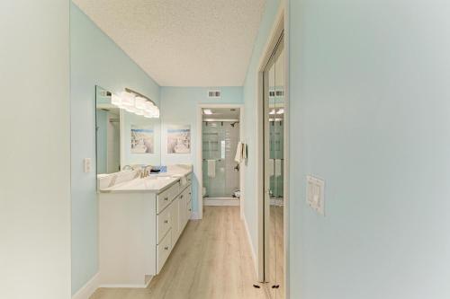 a white bathroom with a sink and a shower at Anna Maria Island Beach Palms 6B in Bradenton Beach