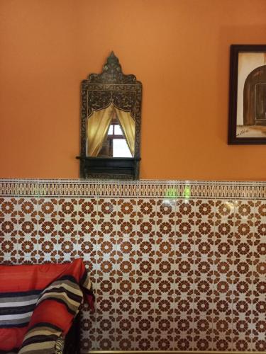 a mirror on the wall of a room at Riad Dar Pa Labzioui in Meknès