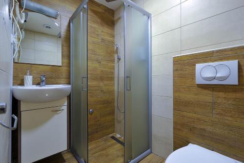 a bathroom with a toilet and a sink and a shower at Vila Mina in Zlatibor