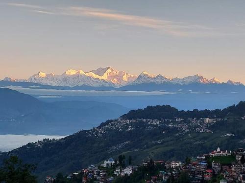 a view of a mountain range with mountains in the background at Yalung Homestay in Darjeeling