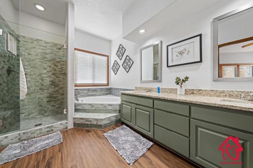 a bathroom with two sinks and a shower and a tub at Pueblo Moon w Pool - An Irvie Home in Alameda