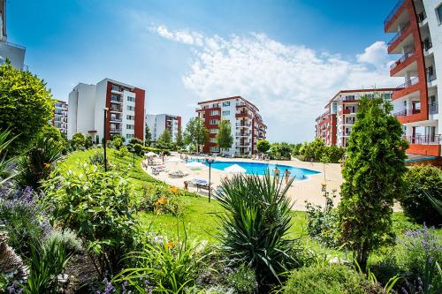 an apartment with a swimming pool and some buildings at Paradise View in Sunny Beach