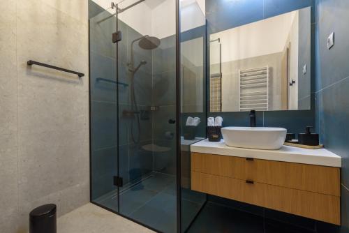 a bathroom with a sink and a glass shower at Spring House Aqualida in Banya