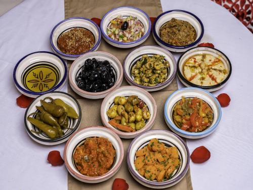 a group of bowls of different types of food on a table at Riad Almisk in Marrakech