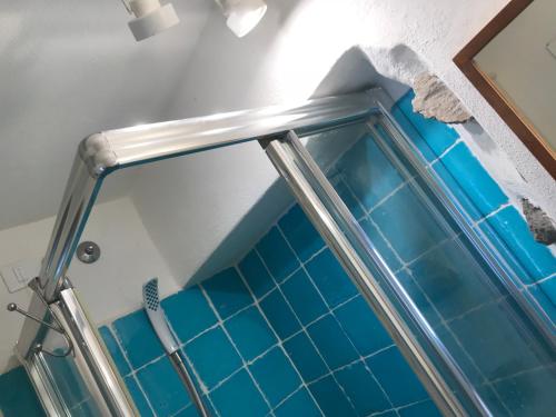 a shower with blue tile in a bathroom at Villa Lavinia in Santa Marina Salina