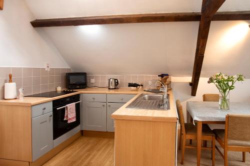 a kitchen with a sink and a stove top oven at Central Stow on the Wold in Stow on the Wold