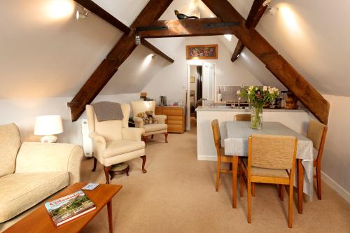 a living room with a table and chairs at Central Stow on the Wold in Stow on the Wold