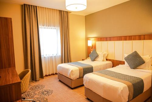 Postel nebo postele na pokoji v ubytování Demure -Razin Serviced Apartments