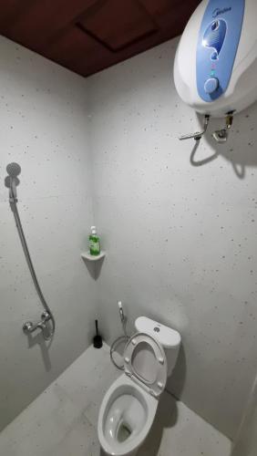 a bathroom with a toilet and a camera on the wall at Batik Inn Semarang in Semarang