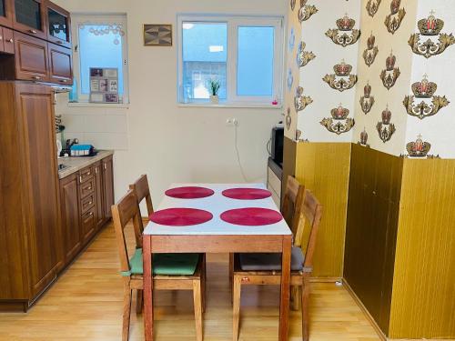 a kitchen with a table with four chairs and a kitchen with at Sweet apartment in Bratislava