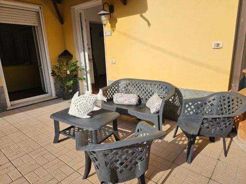 a patio with chairs and a bench and a table at IL PEPE ROSA di Anna e Silvano in Sarzana