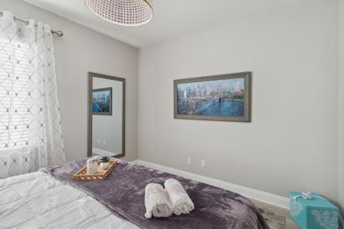a bedroom with a bed with white towels on it at 5BR 3BA Home - King Beds - Fast Wifi home in Victorville