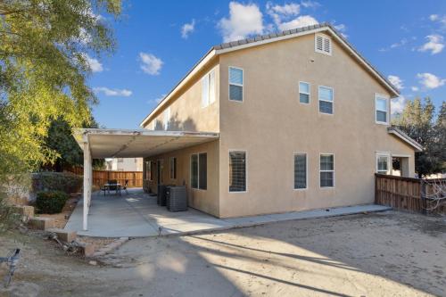 a large house with a garage in front of it at 5BR 3BA Home - King Beds - Fast Wifi home in Victorville