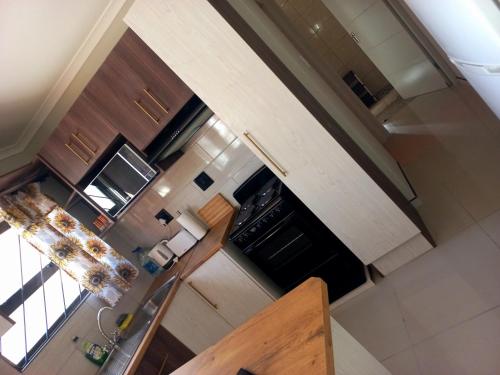 an overhead view of a kitchen with wooden cabinets at TALITHA'S SELF-CATERING ACCOMMODATION in Walvis Bay
