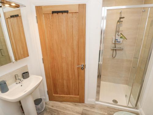 a bathroom with a shower and a sink at The Pepper Pot Retreat in Ventnor