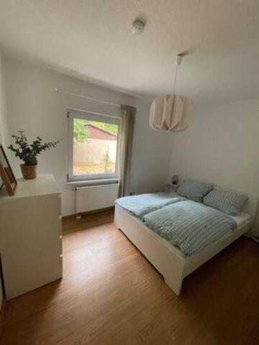 a bedroom with a bed and a window at WaldmeisterInn in Machern