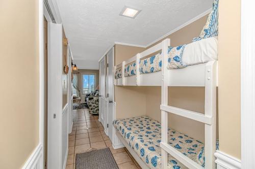 a hallway with bunk beds in a room at Exceptional Ocean-Pier-Pool Front 1 BR Condo in Myrtle Beach