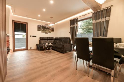 a living room with a couch and a table at Royal House in Zakopane