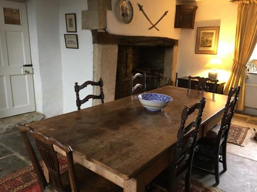 a dining room table with a bowl on top of it at Prebendal Manor in Nassington