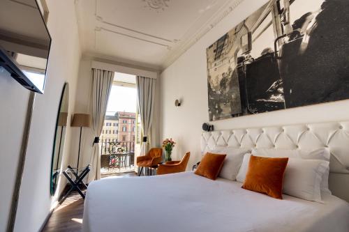 a hotel room with a white bed and a window at Piazza Farnese Luxury Suites in Rome