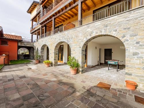 a courtyard with a stone wall with a ping pong table at Rododendro House Relax in Germasino