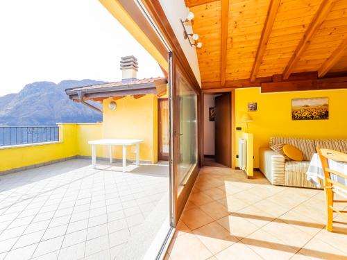 a balcony of a house with a table and a couch at Rododendro House Relax in Germasino