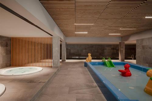 a room with a swimming pool with toys in it at VacationClub – Lwowska 2C Apartament 14 in Kołobrzeg