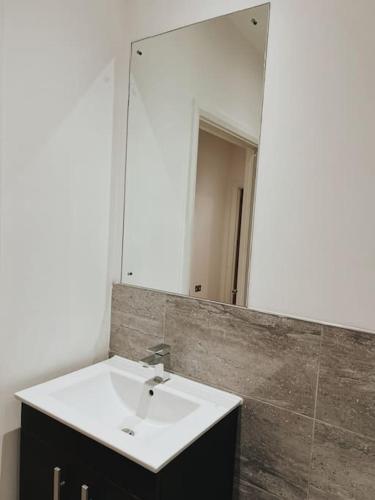 a bathroom with a sink and a mirror at CentralGem Retreat 02 in Redditch