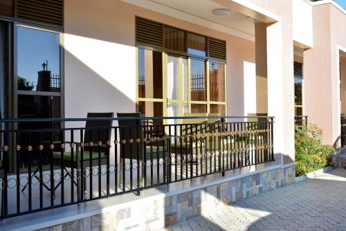 a balcony of a house with a black railing at Jengel Studio Apartments Entebbe 1 in Entebbe
