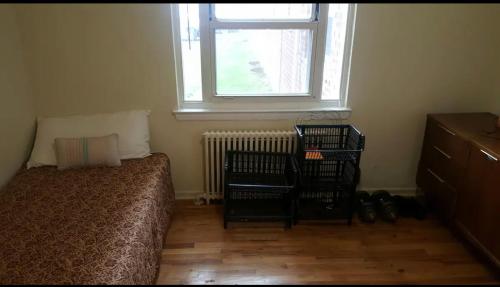 a bedroom with a bed and a window at Suite 55 in Elmwood Park