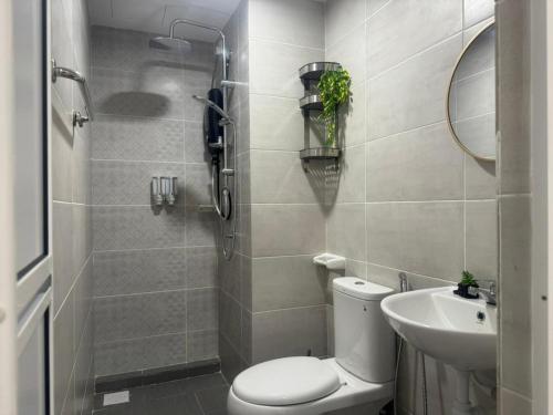a bathroom with a toilet and a sink at Mutiara Beach Resort by Minso Homes in Tangga Batu