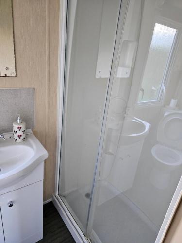 a bathroom with a shower and a sink at 113 Caravan at meadow lakes in St Austell