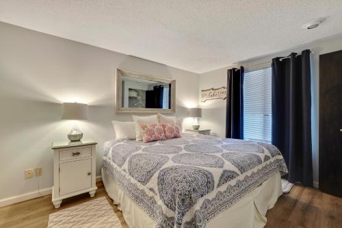 a bedroom with a bed and a mirror on the wall at 345 Edgewater Inn in Charlevoix