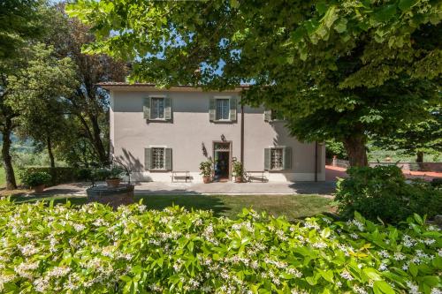 an exterior view of a white house with trees at Borgo I Vicelli Adults Only Relais in Bagno a Ripoli