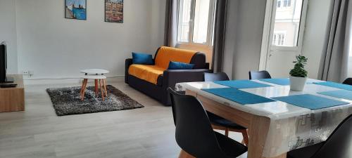 un salon avec une table et un canapé dans l'établissement Appartement Entre terre et mer, à Dunkerque