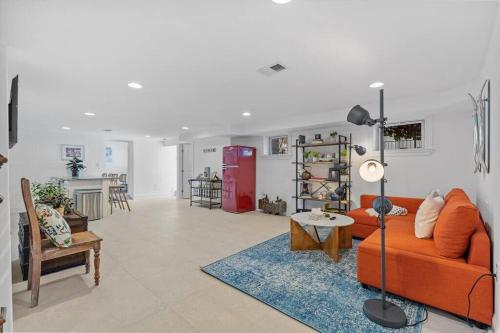 a living room with an orange couch and a table at Stone's Throw from Capitol Hill Free Parking in Washington, D.C.